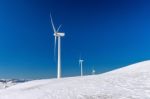 Wind Turbine And Blue Sky In Winter Landscape Stock Photo