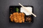 Japanese Food Tonkatsu Rice And Vegetable Take Away On Table Background Stock Photo