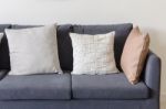 Three Of Pillows On Dark Blue Sofa Stock Photo