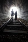 Couple Walking Together Through A Railway Tunnel Stock Photo