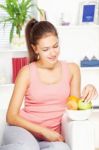 Woman At Home On Sofa With Fruits Stock Photo