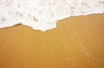 Sea Wave With Foam On Sand Stock Photo