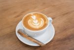 Coffee With Latte Art On Wooden Table Stock Photo