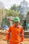 Excavator And Workers Stock Photo