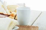 Cup And Bread On Table Stock Photo