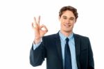 Portrait Of Smiling Businessman Showing Ok Sign Stock Photo