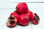 Fresh Pomegranate Fruits Isolated On A White Wooden Background Stock Photo