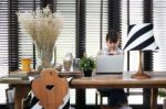 Young Asian Working Woman Is Using A Laptop Stock Photo