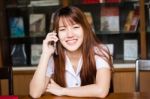 Portrait Of Thai Adult Student University Uniform Beautiful Girl Using Her Smart Phone Stock Photo