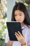 Portrait Of Thai Student Teen Beautiful Girl Using Her Tablet Stock Photo