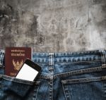 Blue Jeans With Cell Phone And Passport In A Pocket Background Stock Photo