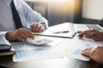 Business Man Working At Office With Laptop, Tablet And Graph Dat Stock Photo