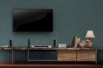 Led Tv On Dark Green Wall With Wooden Media Furniture Stock Photo