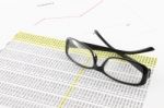 Eye Glasses On Financial Report Stock Photo