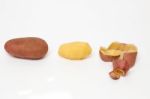 Potato Pealing Process On A White Background Stock Photo