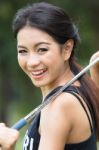 Asian Woman Holding A Golf Stock Photo