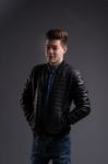 Casual Young Man In Black Leather Jacket And Denim Jeans Stock Photo