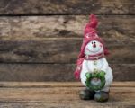 Snowman Standing On Old Wooden Table Stock Photo