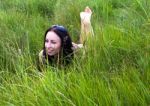 Young Woman Lying On The Grass Stock Photo