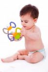 Baby Sitting With Diaper And Playing With Toys Stock Photo