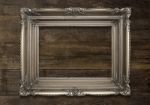 Old Brown Picture Frame On Wooden Background Stock Photo