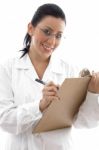 Smiling Doctor Writing On Clipboard Stock Photo