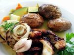 Grilled Octopus, Potatoes And Vegetables Stock Photo