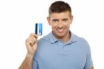 Cheerful Man Holding Credit Card Stock Photo