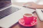 Red Coffee Cup With Notepad And Laptop Stock Photo