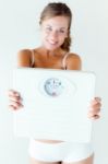 Young Girl In Underwear Holding Scales Stock Photo