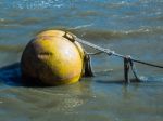 Huge Yellow Buoy Floating In The River Thames Stock Photo