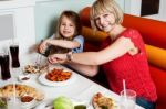 Mother And Daughter In A Restaurant Stock Photo