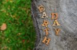 Wooden Earth Day Word On Wood Log Background. Save The Earth Idea Stock Photo