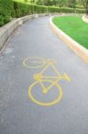 Yellow Bicycle Sign On Curve Park Road Stock Photo