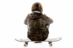 Back Pose Of Boy Sitting On Skate Stock Photo