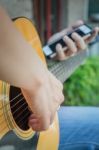 Guitarist Hand Playing Acoustic Guitar Stock Photo