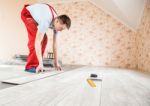 Handyman Laying Down Laminate Flooring Boards Stock Photo