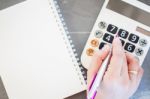 Hand With Calculator And Notepad Stock Photo