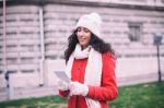 Beautiful Woman In Red Coat And Wool Cap And Gloves With Smartph Stock Photo