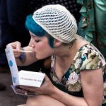 Lady Enjoying A Take Away At The Goodwood Revival Stock Photo