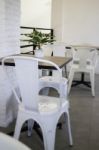 White Steel Chair And Wooden Table Stock Photo