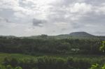 Green Landscape With Hill In The Background Stock Photo