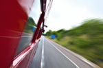 Red Old Bus Going Fast On The Highway Stock Photo