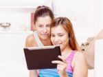 Happy Teenage Girls Using Touchpad Stock Photo