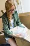 Young Beautiful Woman Moving In A New Home Stock Photo