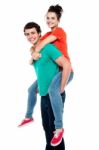 Male Giving Piggyback Ride Stock Photo