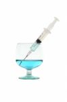 Syringe Suck Blue Liquid From Glass On White Background Stock Photo