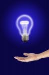 Hand Holding Electric Light Bulb Stock Photo