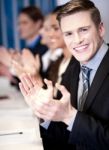 Business Associates Applauding, Focus On Guy Stock Photo