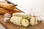 Baguette With Herb Butter And Rosemary Thyme On Rustic Wooden Background Stock Photo